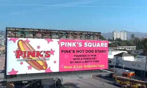 Skyline view of Los Angeles billboard showing Pink's Square announcement