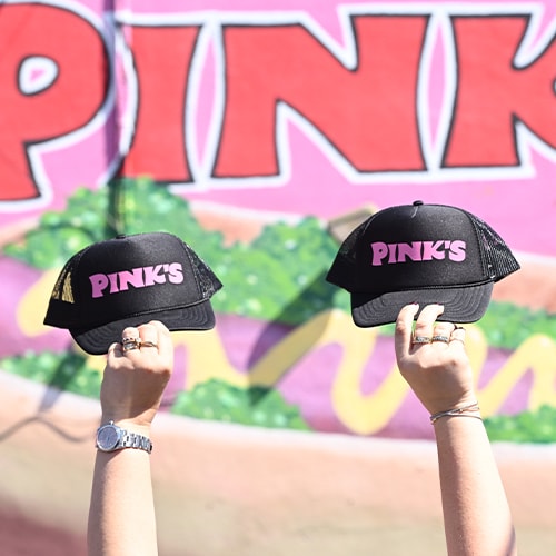 Two black ball cap with the Pink's logo on them.